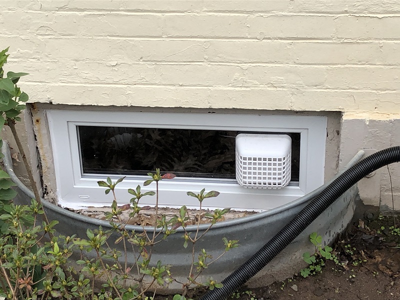 Custom basement window with a dryer vent 